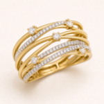 Close detail of layered gold-tone bands and clear accent stones