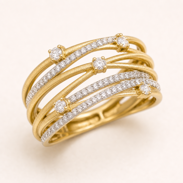 Close detail of layered gold-tone bands and clear accent stones