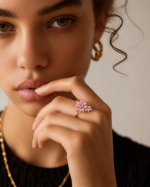 Model hand wearing a pink floral stone ring