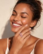 Model hand wearing a pink dragonfly ring
