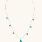 Full teal drop necklace on a warm white background