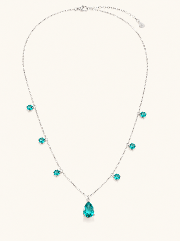 Full teal drop necklace on a warm white background